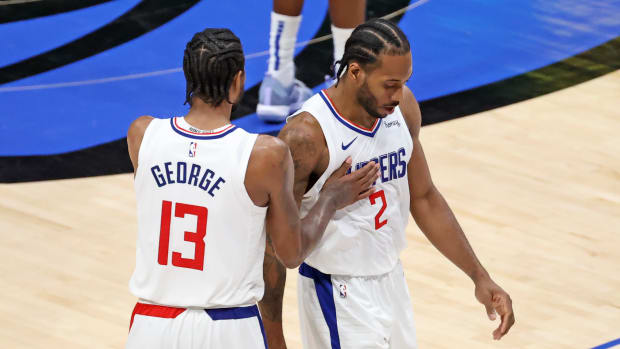 Jun 4, 2021; Dallas, Texas, USA; LA Clippers forward Kawhi Leonard (2) celebrates with guard Paul George (13) during the fourth quarter against the Dallas Mavericks during game six in the first round of the 2021 NBA Playoffs at American Airlines Center. Mandatory Credit: Kevin Jairaj-USA TODAY Sports